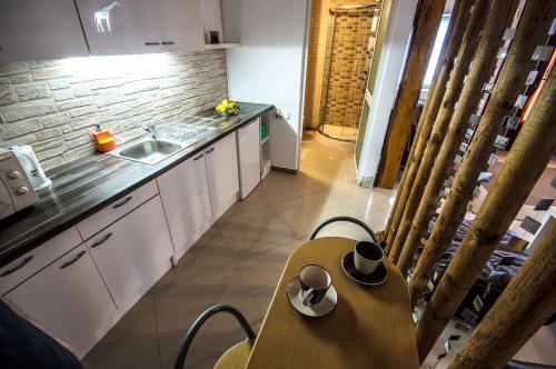 a kitchen with a table and a sink and a counter at NEUSTADT Villa in Cristian
