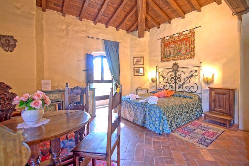 a bedroom with a bed and a table at Santa Flora by PosarelliVillas in Capolona