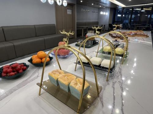 a buffet of food on a table with fruits and vegetables at GreenTree Eastern Hotel Yiwu International Trade City in Yiwu
