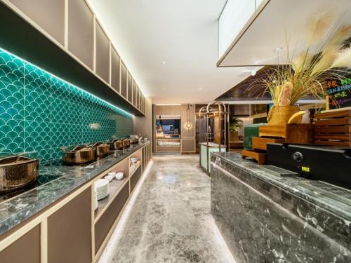 a kitchen with a counter with pots and pans at GreenTree Eastern Hotel Nanjing Jiangning University in Jiangning