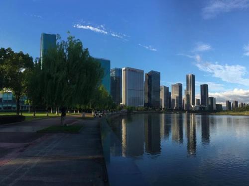 a city skyline with a body of water and a city at GreenTree Eastern Hotel Yiwu International Trade City in Yiwu