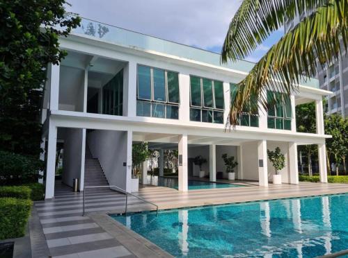a house with a swimming pool in front of a building at Bella Homestay by AK Group in Cyberjaya