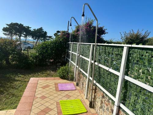 a garden with a fence and a purple and green mat at Residence Costa Tirrena in Torrenova
