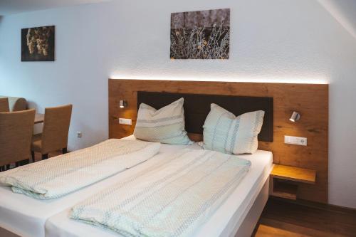 a bedroom with a bed with two pillows on it at Ferienweingut SerwaziWein in Mesenich