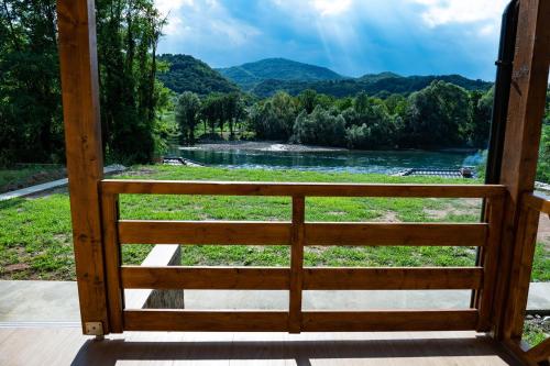 a view from the porch of a cabin with a view of a river at Apartmani Zavičaj Gornja Trešnjica in Ljubovija