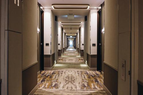 an empty corridor of a hotel with a long aisle of halls at Crowne Plaza Belgrade by IHG in Belgrade