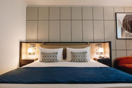 a bedroom with a large bed with two pillows at Crowne Plaza Belgrade by IHG in Belgrade