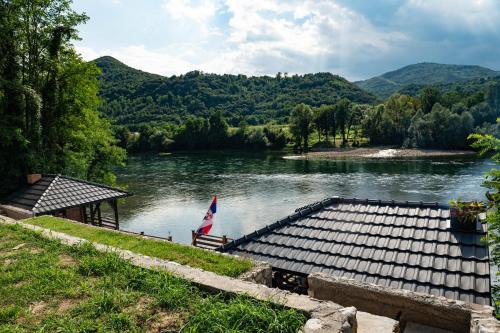 a view of a river with a wooden dock at Apartmani Zavičaj Gornja Trešnjica in Ljubovija