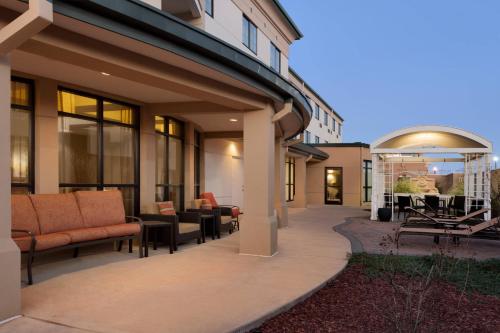 a patio with couches and tables on a building at Courtyard by Marriott Oklahoma City North/Quail Springs in Oklahoma City