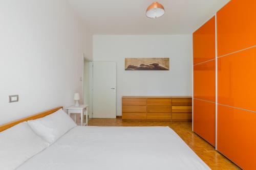 a bedroom with a bed and an orange cabinet at Casa Limone by Wonderful Italy in Bologna