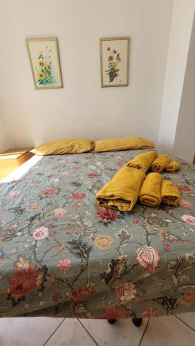 a bed with yellow pillows on it in a room at Dimora1 MGM in Marconia