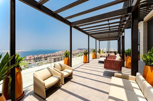 a balcony with chairs and a view of the ocean at Hyatt Centric Jumeirah Dubai in Dubai