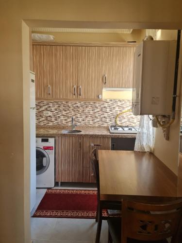 a kitchen with a table and a washing machine at BYCOACH TRAVEL APARTMENT in Istanbul