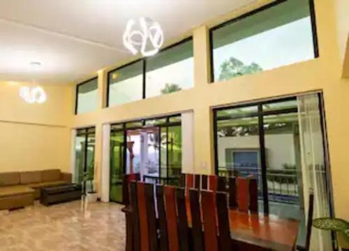 a living room with glass windows and a couch at CIDNYLAND FARM AND RESORT TANAY in Tanay