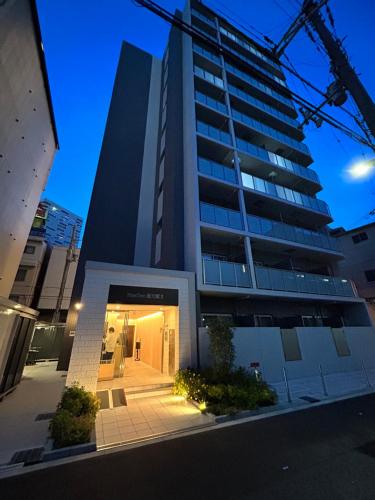 a tall building with a hallway in front of it at Seiryu Tsutenkaku in Osaka