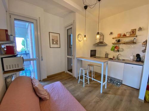 a living room with a table and a kitchen at Fevira Suite Airport Free Parking in Florence