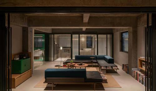 a living room with a blue couch and a table at Jiangnan House Nantou in Shenzhen