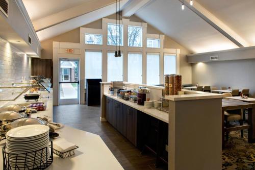 a large kitchen with a large counter and some windows at Residence Inn Fairfax Merrifield in Merrifield