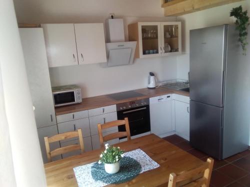 a kitchen with white cabinets and a table with a plant at Wohnung mit Ausblick in Ravensburg