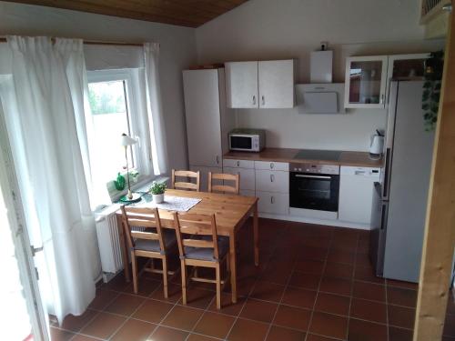 a kitchen with a table and chairs and a refrigerator at Wohnung mit Ausblick in Ravensburg