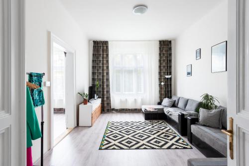 a living room with a couch and a rug at Prague - Karlin Apartments in Prague