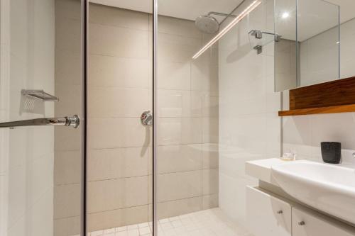 a bathroom with a shower and a sink at 602 Zimbali Suites, Ocean View in Ballito