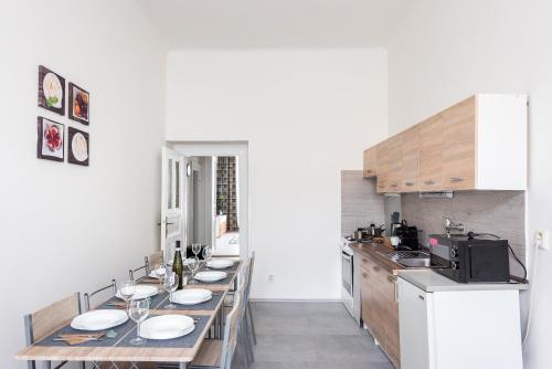 a kitchen with a long table with plates on it at Prague - Karlin Apartments in Prague