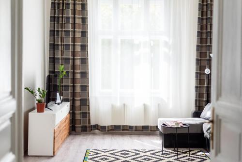 a living room with a couch and a window at Prague - Karlin Apartments in Prague
