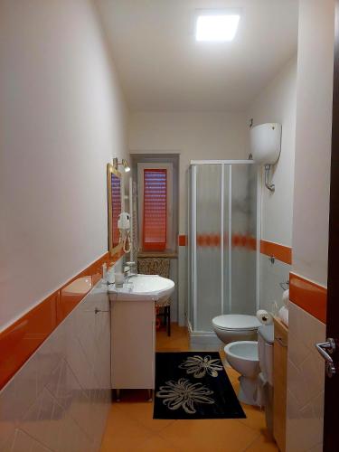 a bathroom with a shower and a sink and a toilet at Villa Margot in Agropoli