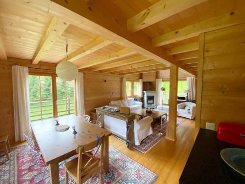 a large living room with a table and a couch at Chalet with style in the beautiful Val Ferret in Praz-de-Fort