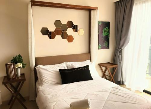 a bedroom with a bed with a black and brown headboard at Timurbay Seafront Residence & Suites in Kuantan