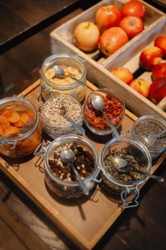 a tray filled with different types of food in jars at Martin's Château Du Lac in Genval