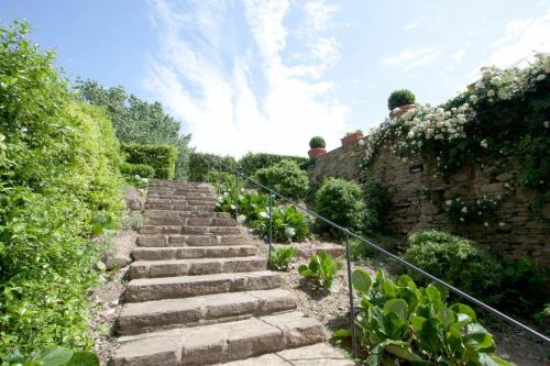 a set of stone stairs in a garden at Santa Flora by PosarelliVillas in Capolona