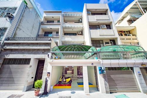 an apartment building with a playground in front of it at Long Stay Here in Tainan