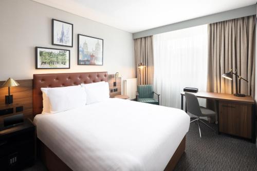 a hotel room with a large bed and a desk at Four Points by Sheraton Edinburgh in Edinburgh