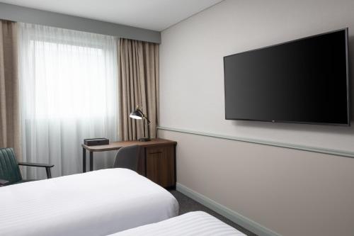 a hotel room with two beds and a flat screen tv at Four Points by Sheraton Edinburgh in Edinburgh