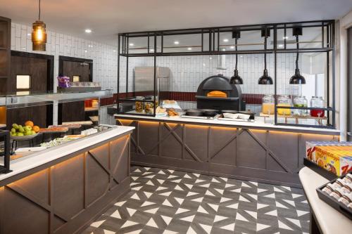 a kitchen with a counter with food on it at Four Points by Sheraton Edinburgh in Edinburgh