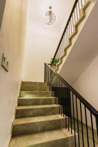 a staircase in a house with a chandelier at LAKE VILLA by CARLSEN in Moratuwa