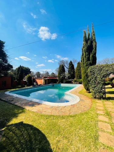 a swimming pool in the yard of a house at Crystal Mini Pozz Palace in Johannesburg
