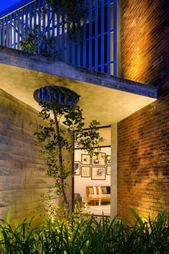 a house with a brick wall and a staircase at LAKE VILLA by CARLSEN in Moratuwa