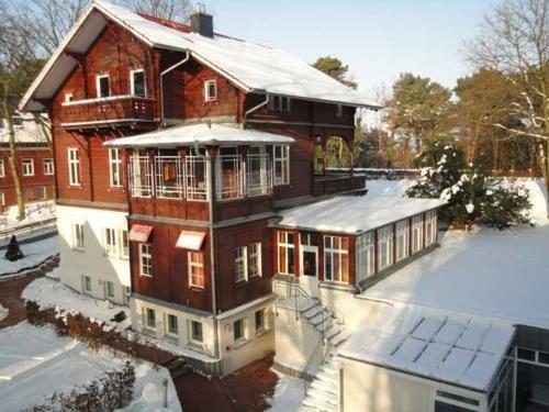 ein großes Haus mit Schnee auf dem Boden in der Unterkunft Ostseepark Waterfront Captains Haus 17 in Heringsdorf