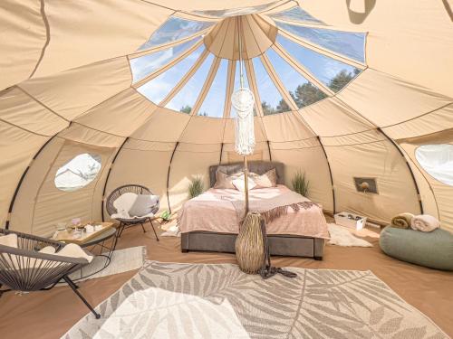 a bedroom with a bed in a tent at Ranna Surfiküla in Suureranna