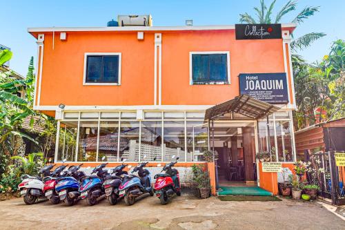 a row of motorcycles parked in front of a building at Hotel Joaquim Near Baga Beach in Baga