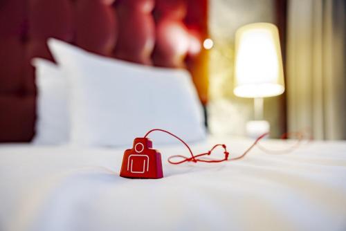 a red object sitting on top of a bed at Crowne Plaza Amsterdam - South by IHG in Amsterdam