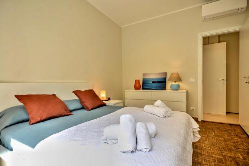 a bedroom with a bed with towels on it at Casa Riva - Few minutes from beaches in Rapallo