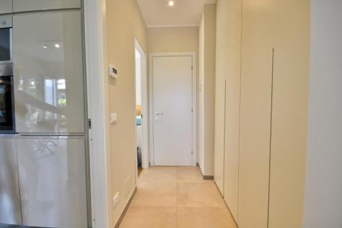 a hallway leading to a kitchen with a refrigerator at Casa Riva - Few minutes from beaches in Rapallo