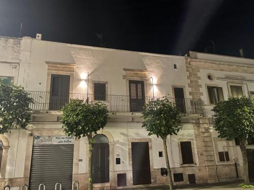 a white building with trees in front of it at Monlochèl in Noci