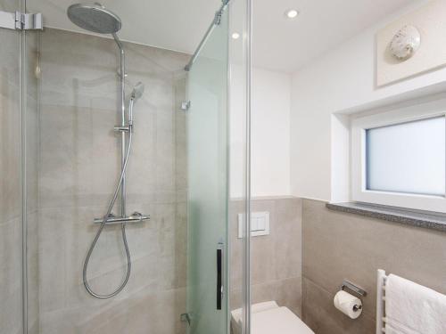 a bathroom with a shower with a glass door at Nautilus-12 in Kampen