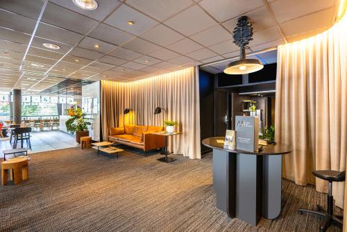 a lobby with a couch and a table in a room at ibis Strasbourg Centre Les Halles in Strasbourg