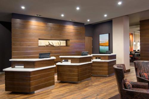 a lobby with two reception desks and chairs at Courtyard by Marriott Irvine Spectrum in Irvine